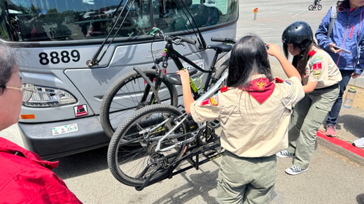 scouts putting bikes on muni