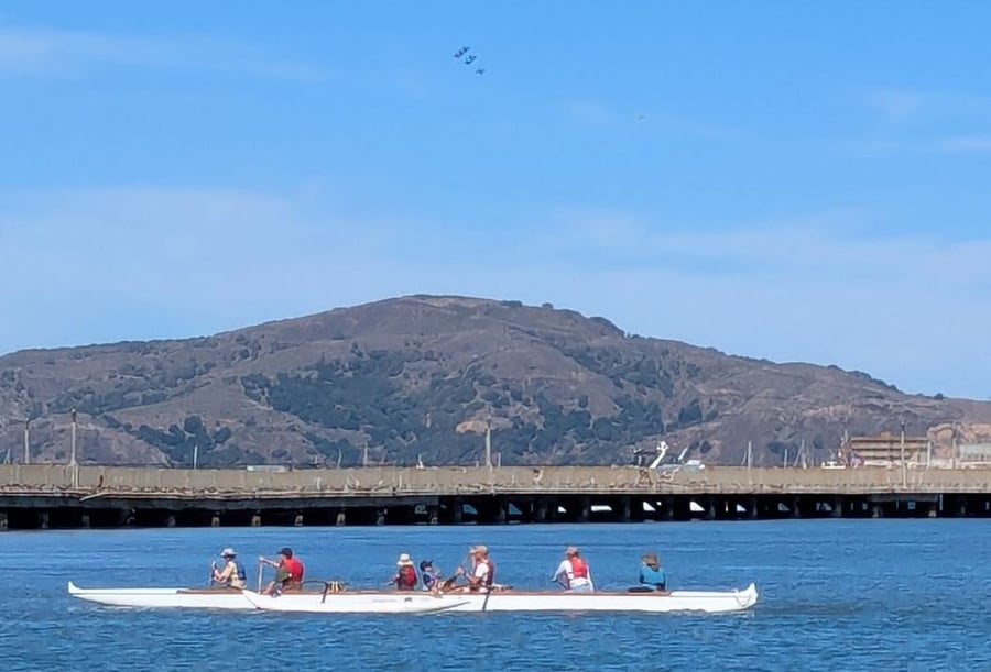 Kids paddling in outrigger canoe at Fleet Week airshow in Aquatic Park